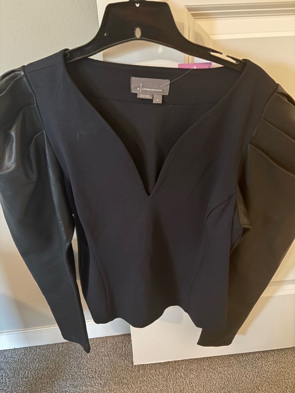 Anthropologie black top,sleeves are faux leather, worn twice. Size M